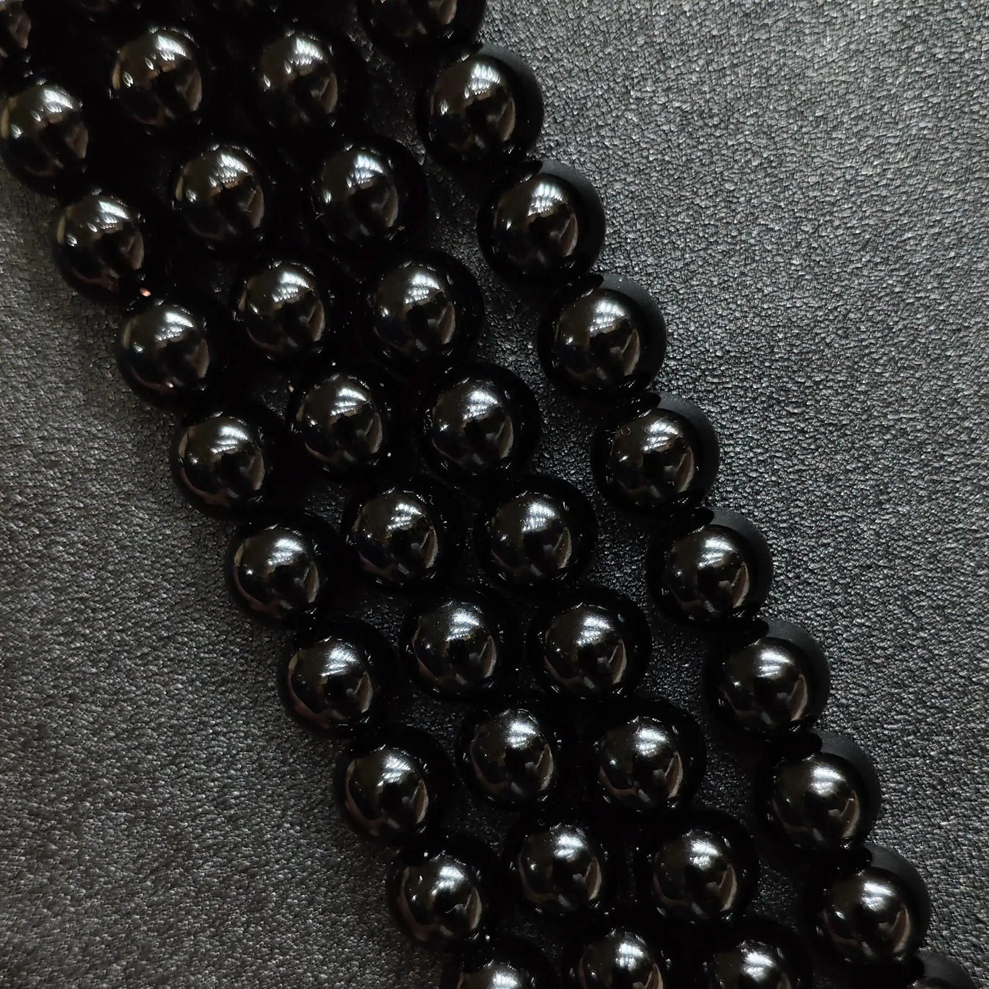 Natural pure black obsidian crystal beads round strands in a high gloss mirror finish