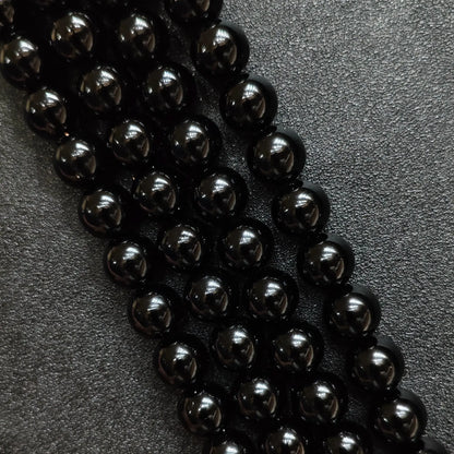 Natural pure black obsidian crystal beads round strands in a high gloss mirror finish