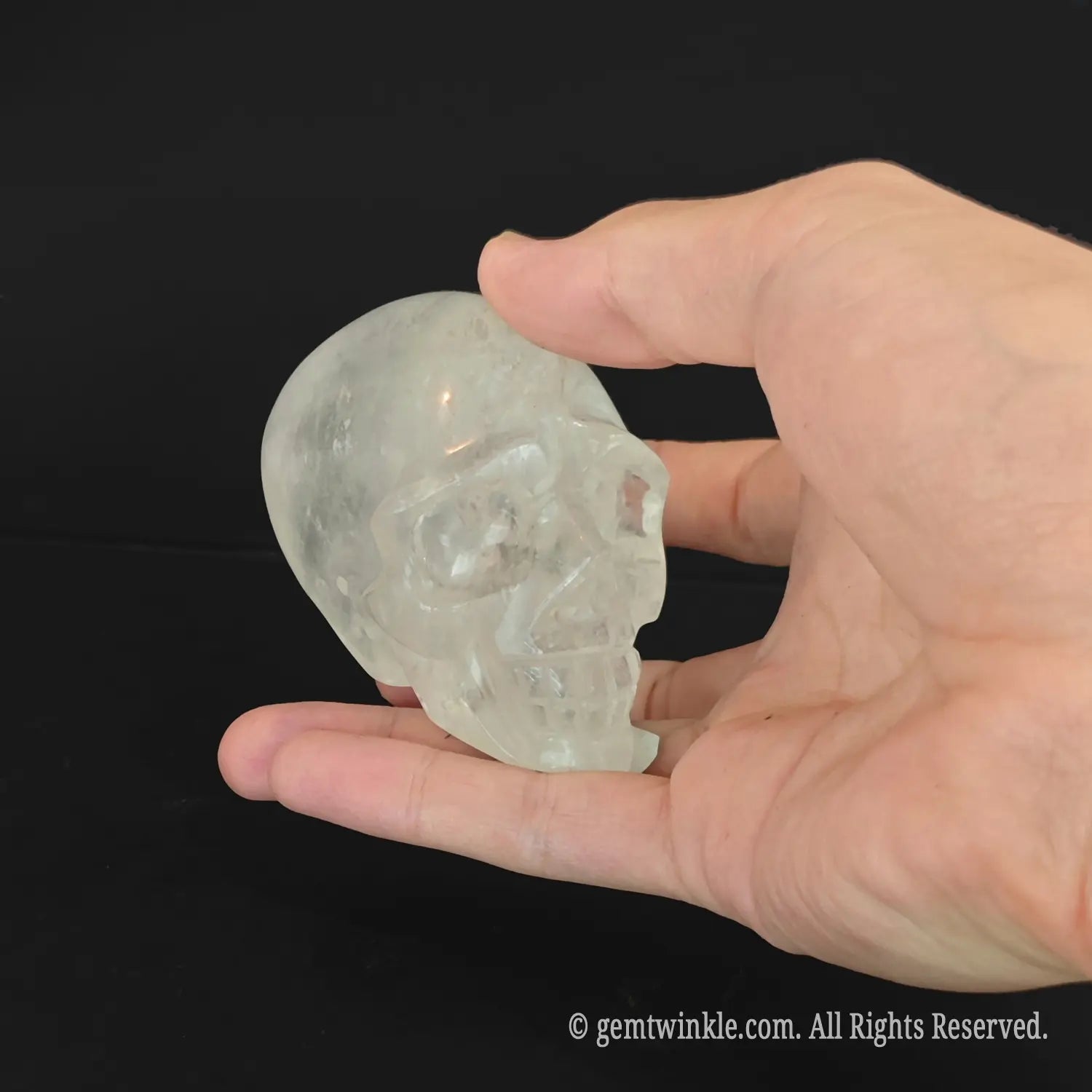Top-down view of quartz skull carving showcasing authentic opaque and inclusion-rich mineral structure