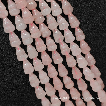 Natural rose quartz gourd bead strand held over hand showing size scale
