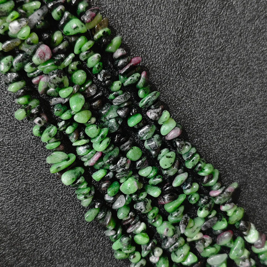 Macro closeup of natural ruby in zoisite chip beads showing green and ruby inclusions