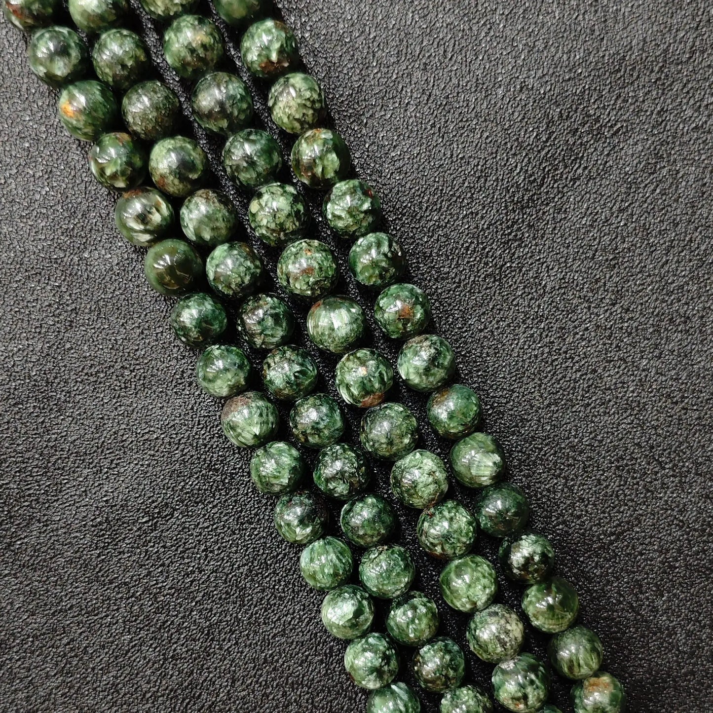 Natural seraphinite crystal beads grade b plus showing beautiful forest green shades and silvery feather patterns