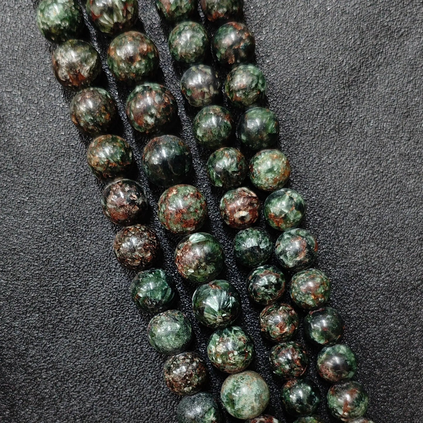 Natural seraphinite crystal beads grade c showing prominent reddish brown matrix and deep forest green patterns