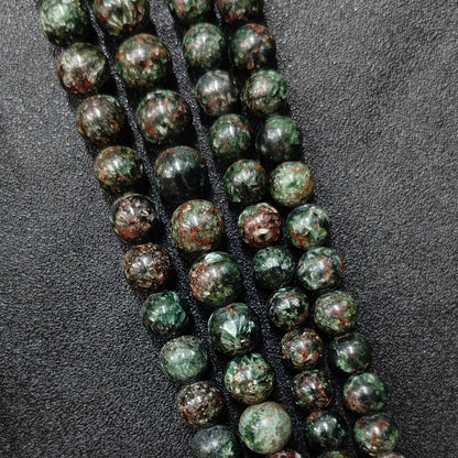 Natural seraphinite crystal beads grade c showing prominent reddish brown matrix and deep forest green patterns
