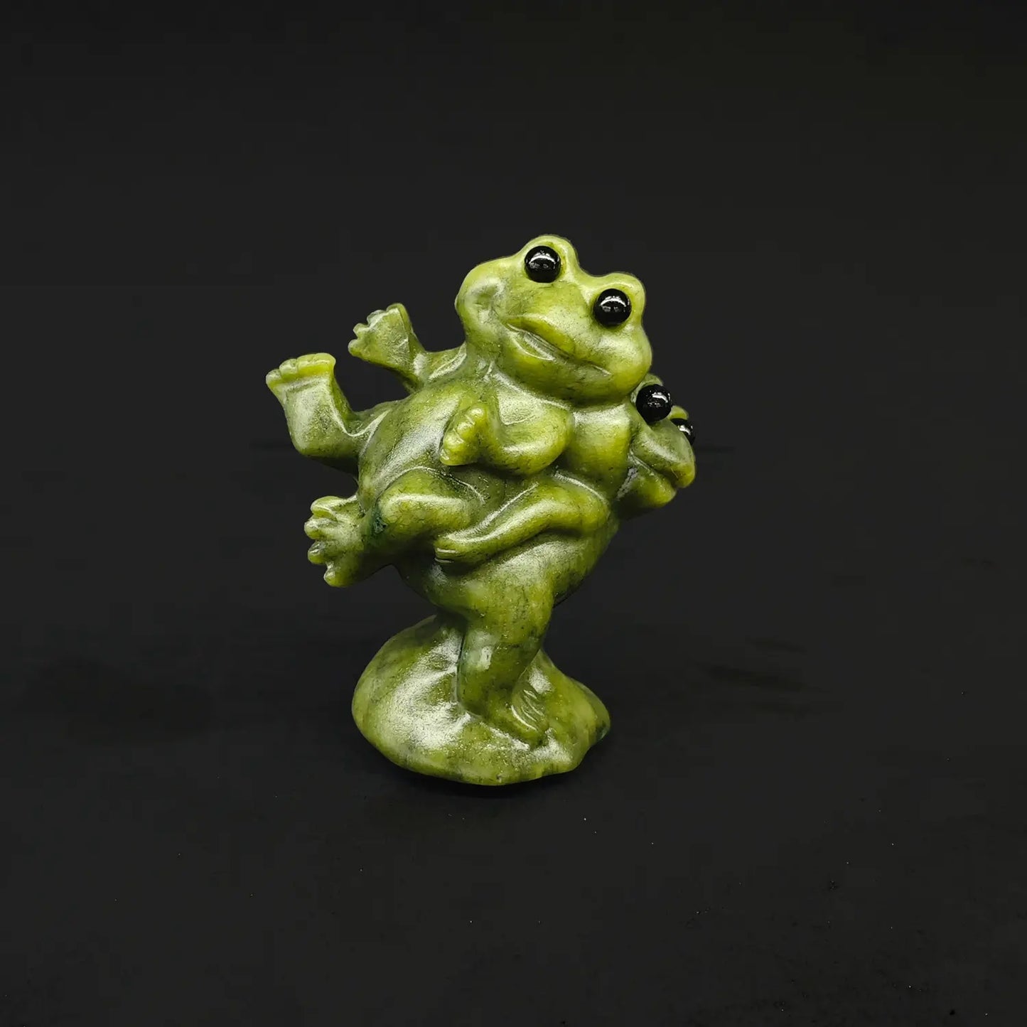 Front side view of a natural serpentine frog piggyback statue showing a large smiling toad carrying his smaller wife on his back