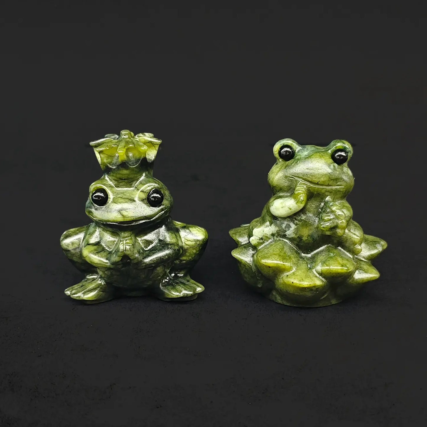 Front view of a natural serpentine frog prince and princess statue pair showcasing a crowned toad prince next to a princess sitting on a lotus base