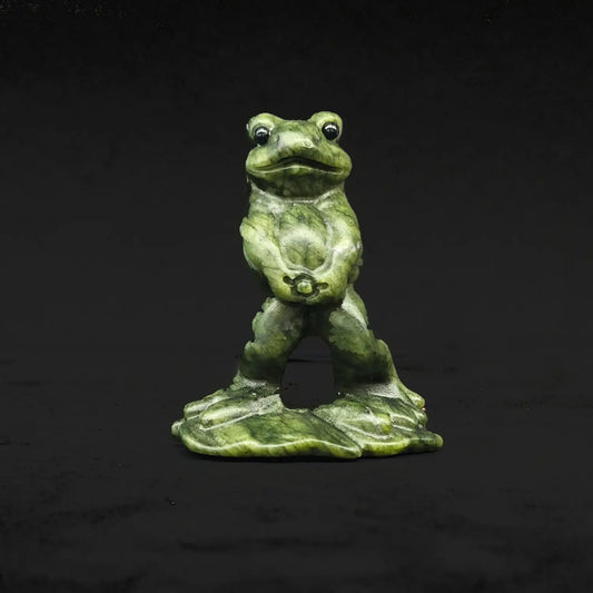 Front view of a natural serpentine peeing frog statue displaying a funny wide eyed toad standing upright in a hilarious pose