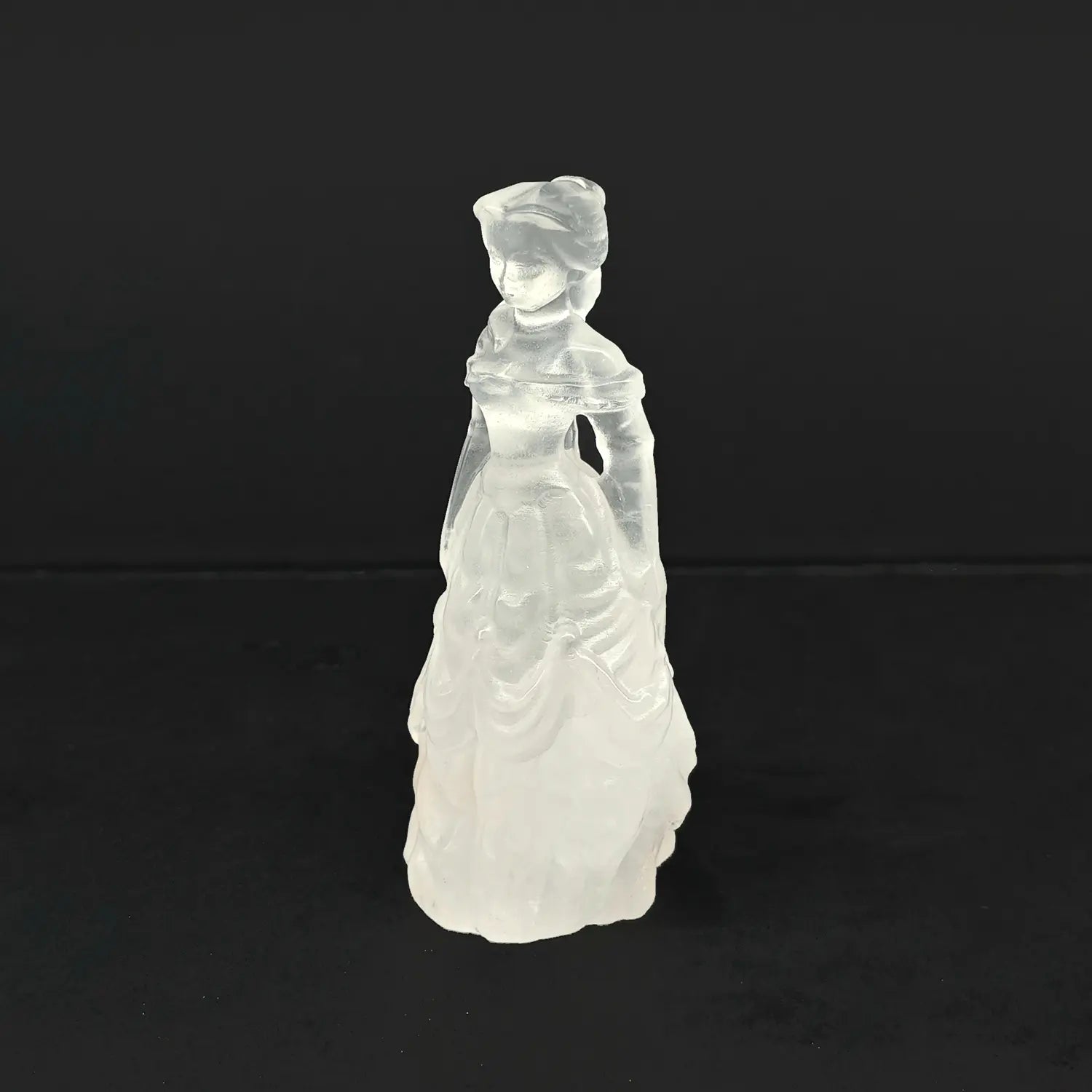 A 4-inch hand-carved natural snow quartz princess statue featuring an opaque milky white tiered ball gown on a dark background