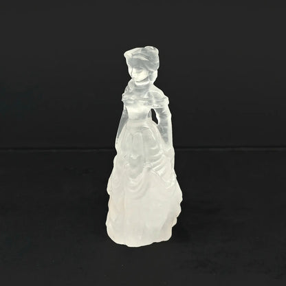 A 4-inch hand-carved natural snow quartz princess statue featuring an opaque milky white tiered ball gown on a dark background