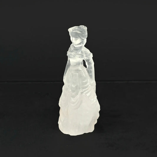 A 4-inch hand-carved natural snow quartz princess statue featuring an opaque milky white tiered ball gown on a dark background