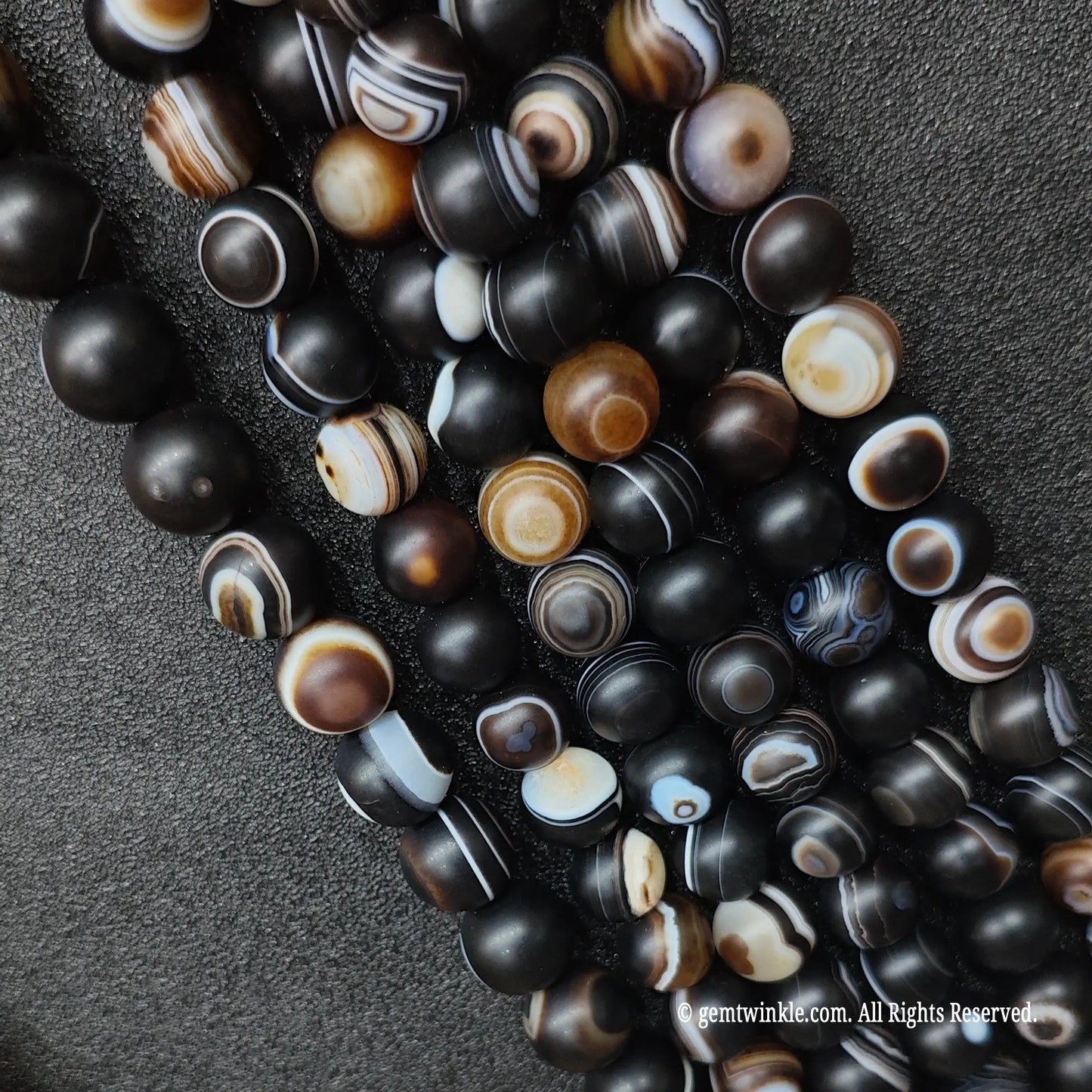 standard grade natural stones for jewelry making wholesale displaying frosted round eye agate strands with diverse pattern ratios