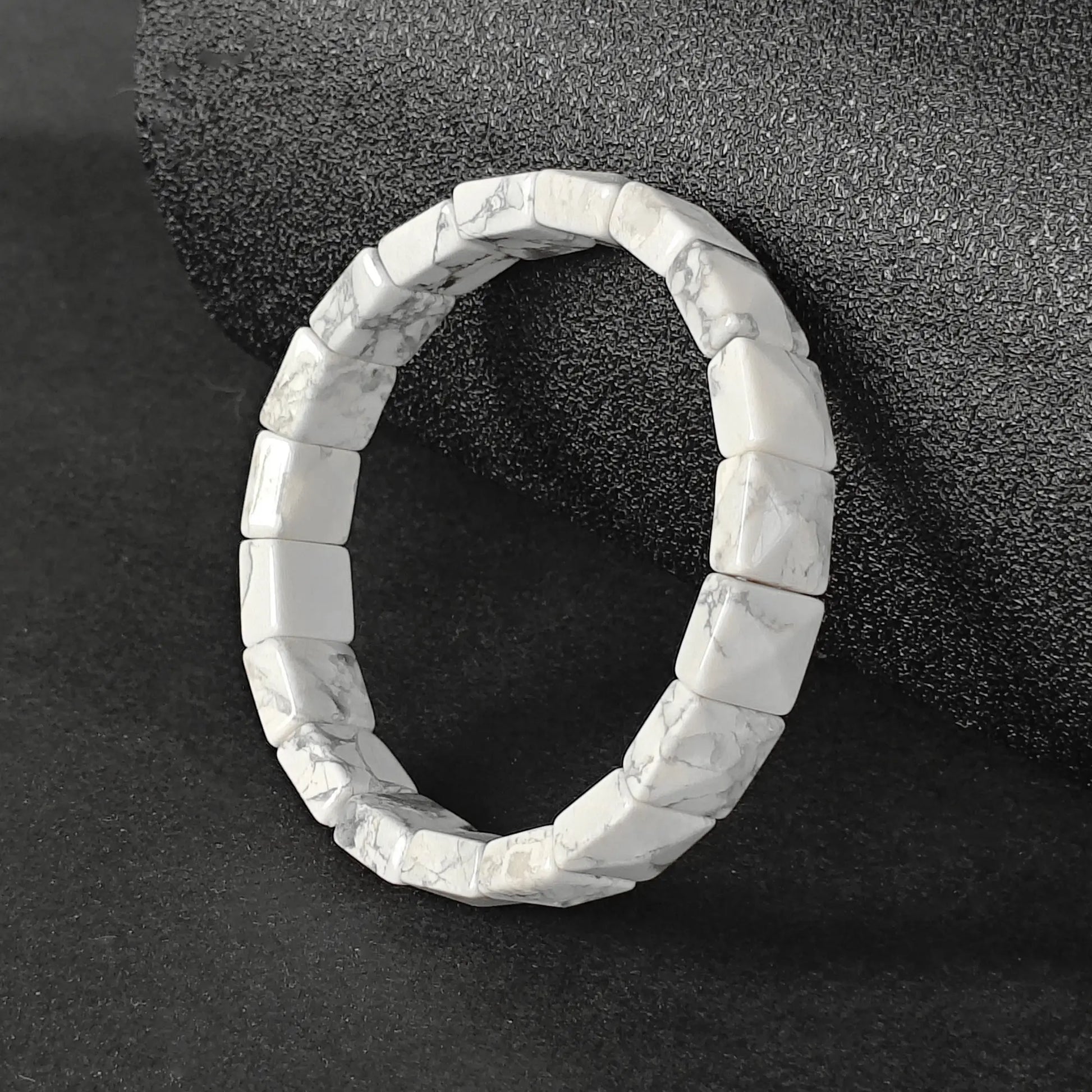 Natural white howlite dainty plate cuff bracelet with grey matrix veins on dark background