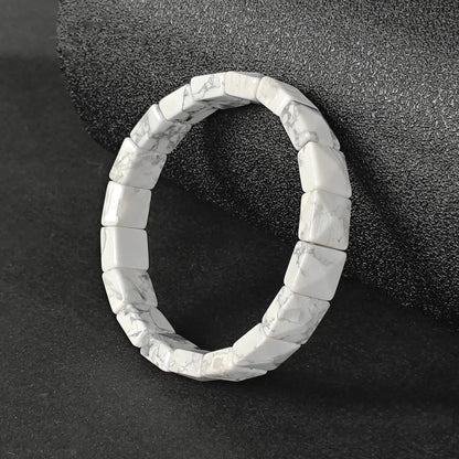 Natural white howlite dainty plate cuff bracelet with grey matrix veins on dark background