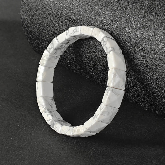Natural white howlite dainty plate cuff bracelet with grey matrix veins on dark background