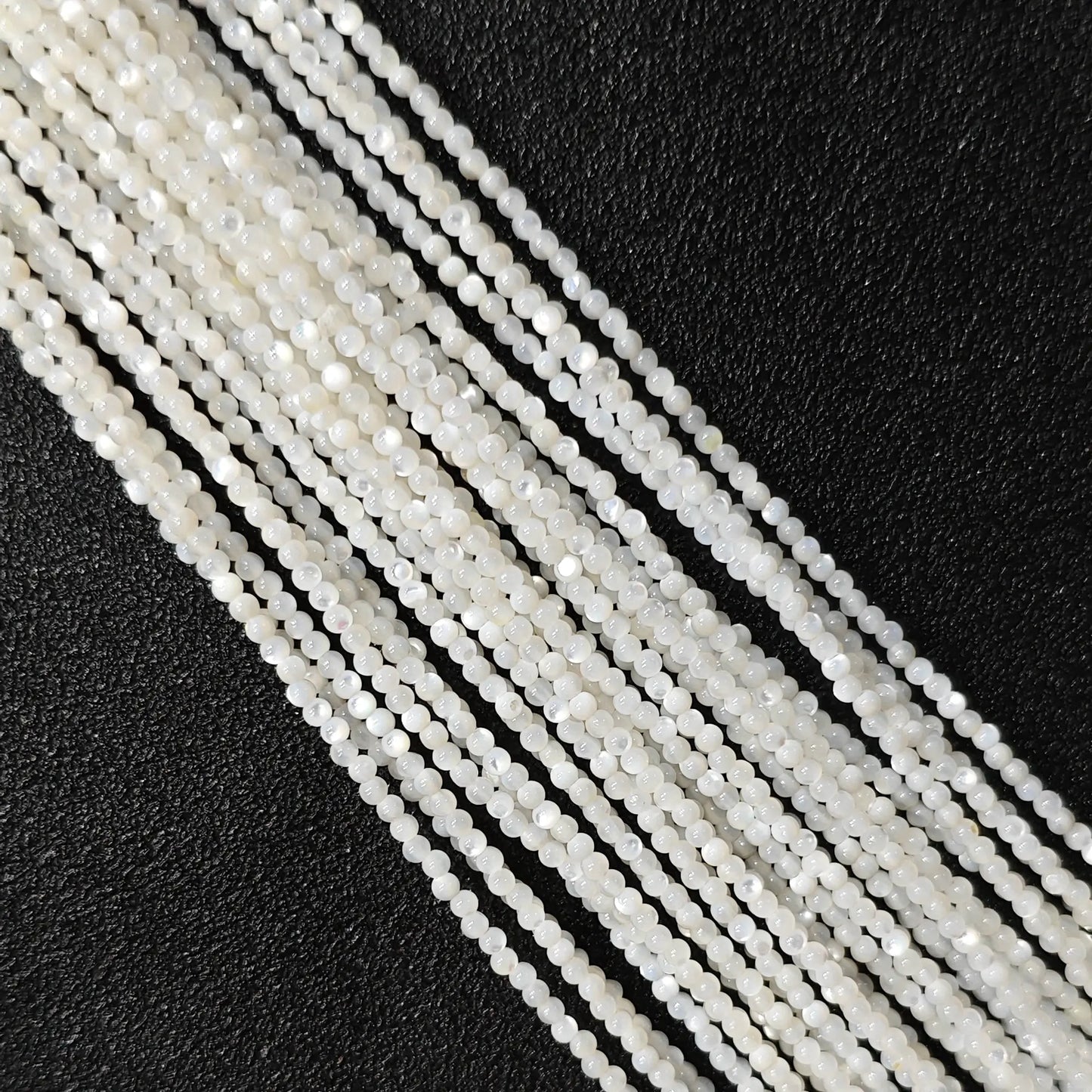 Natural white mother of pearl micro seed beads smooth luster close up view