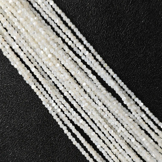 Natural white mother of pearl micro seed beads smooth luster close up view