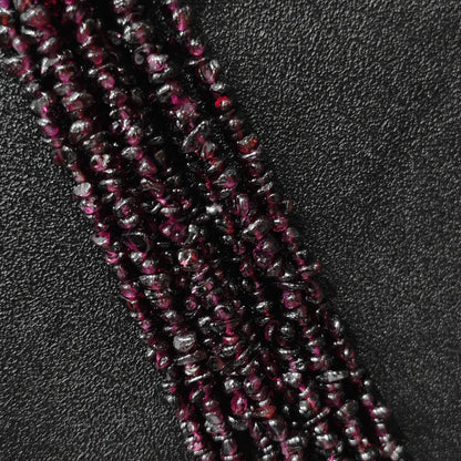 Macro closeup of natural wine red garnet freeform chip beads showing deep red tones