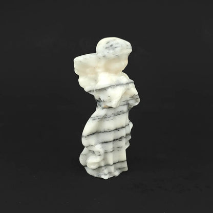 A 10cm hand-carved natural zebra stone praying guardian angel figurine with parallel black and white stripes on a dark background for minimalist room decor