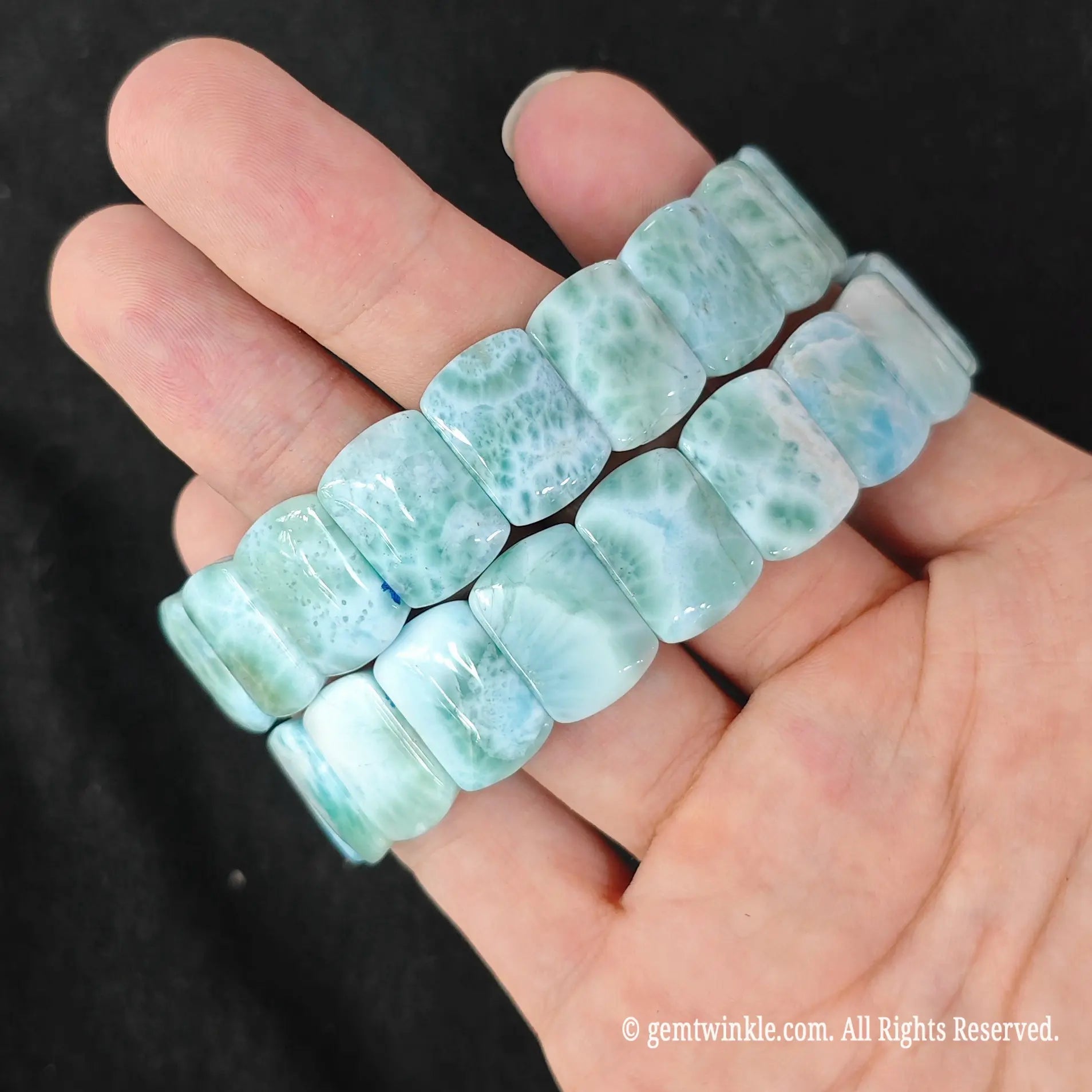 Two natural larimar stretch bracelets held together highlighting sky blue and green volcanic web patterns