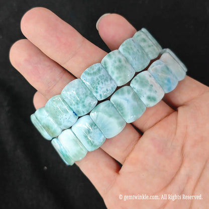 Two natural larimar stretch bracelets held together highlighting sky blue and green volcanic web patterns