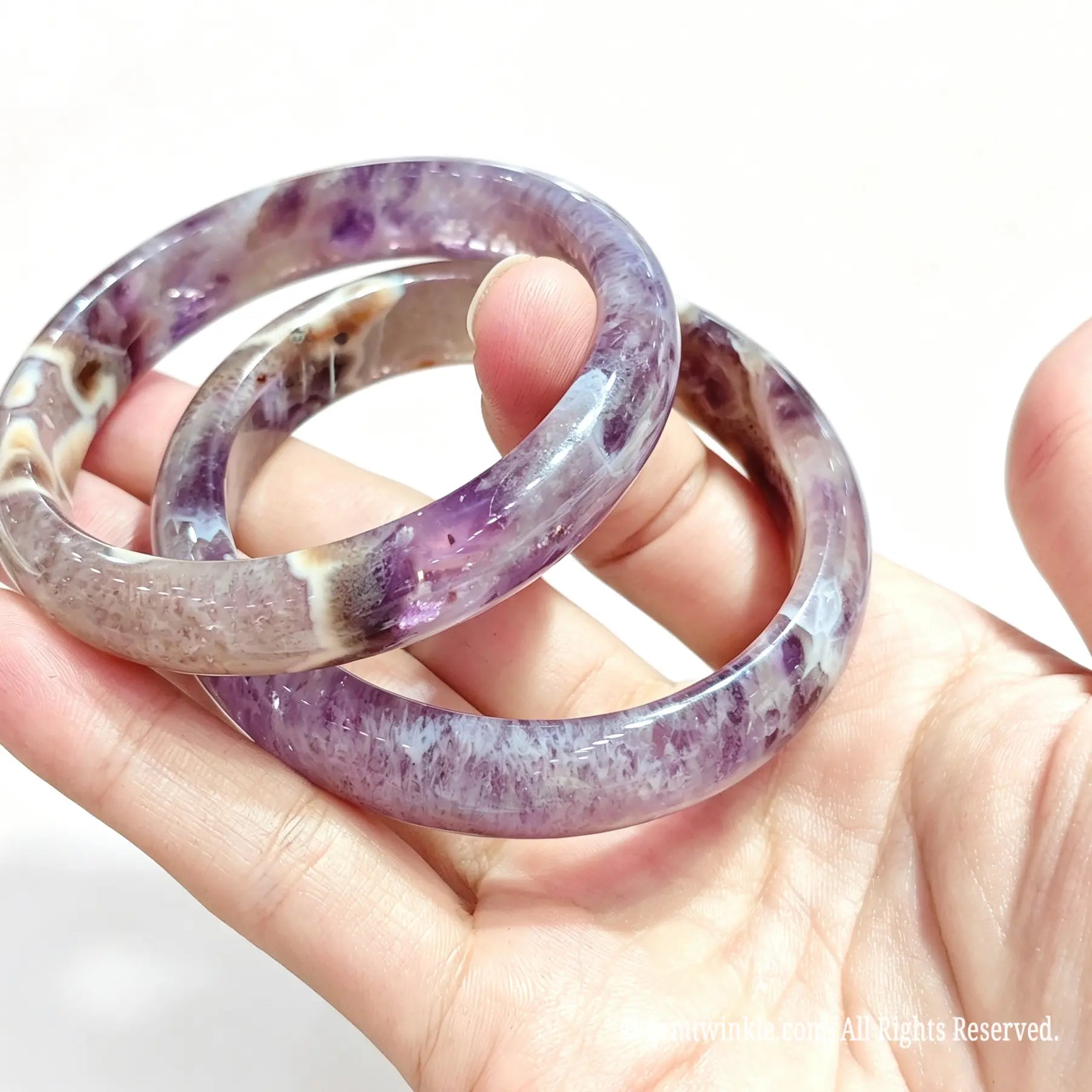 Side view of polished natural amethyst agate bangle displaying high surface luster and natural geode patterns