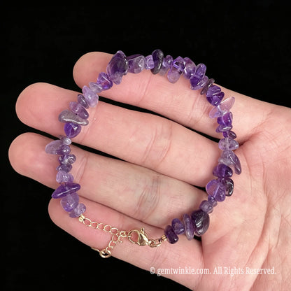 freeform amethyst crystal chip bracelet with gold finish accents on palm view
