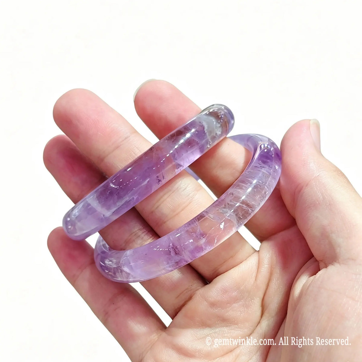 Side profile of light purple amethyst gemstone bangles showing smooth polished edges