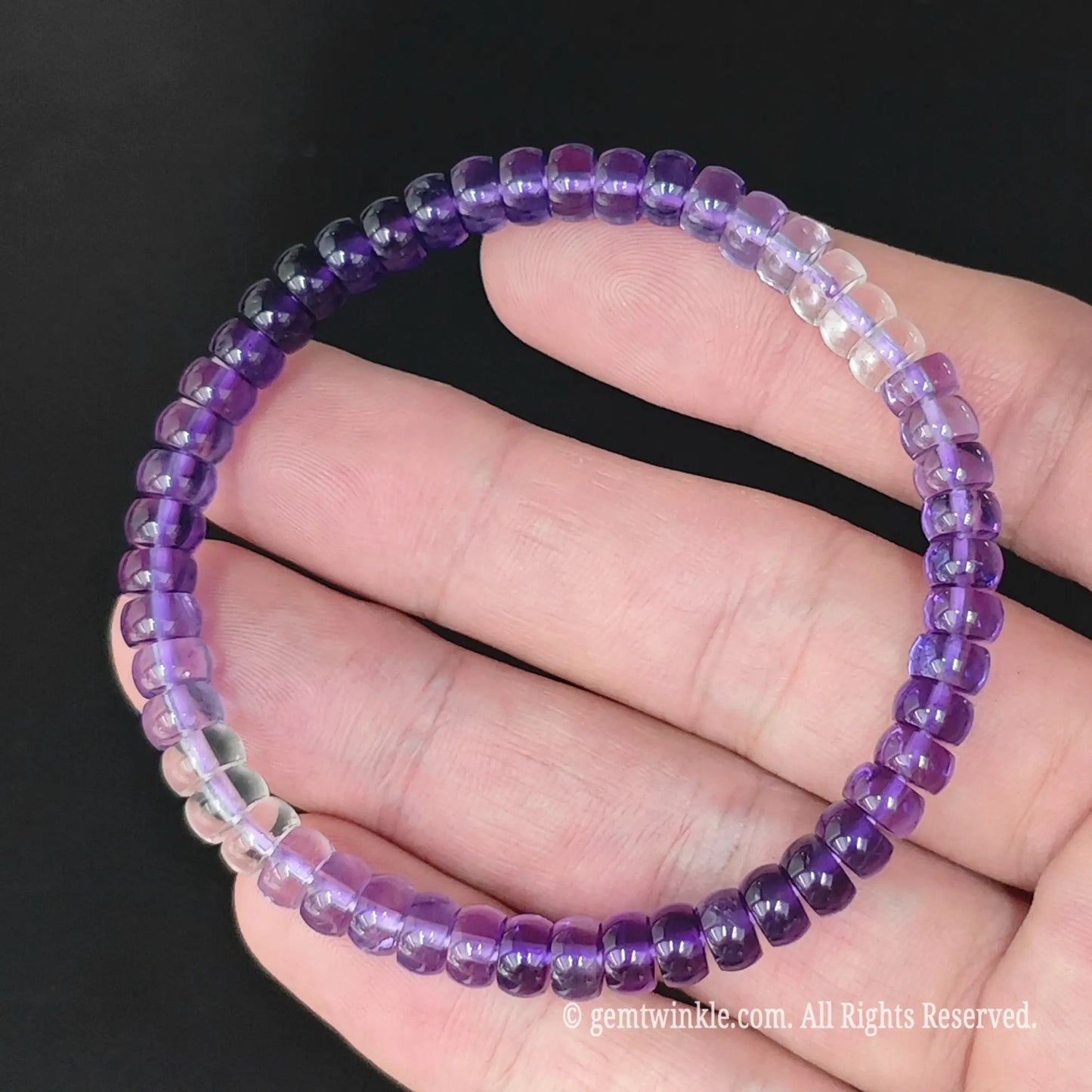 Natural amethyst straight cut abacus bead bracelet held in hand showing high transparency and gloss finish