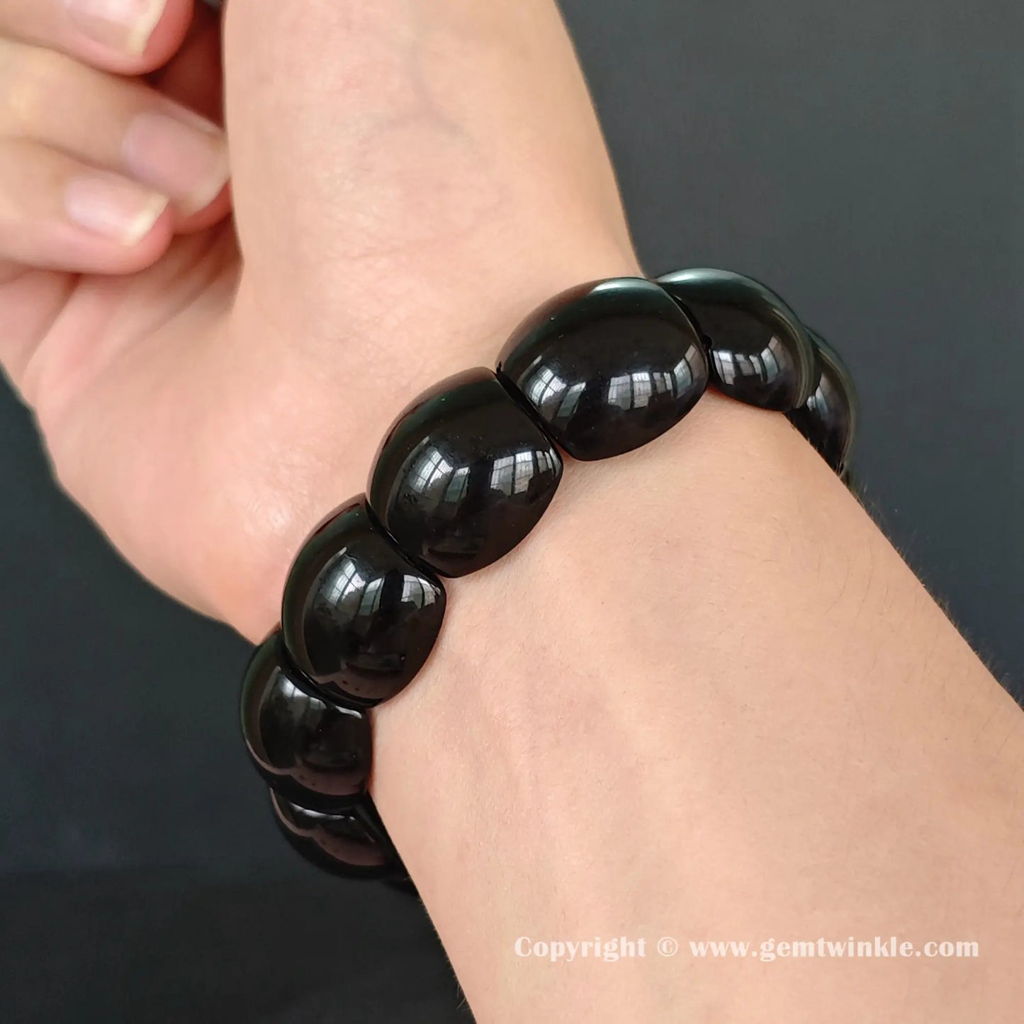 black obsidian plate cuff bracelet on wrist showing 18cm fit and smooth curved geometric beads
