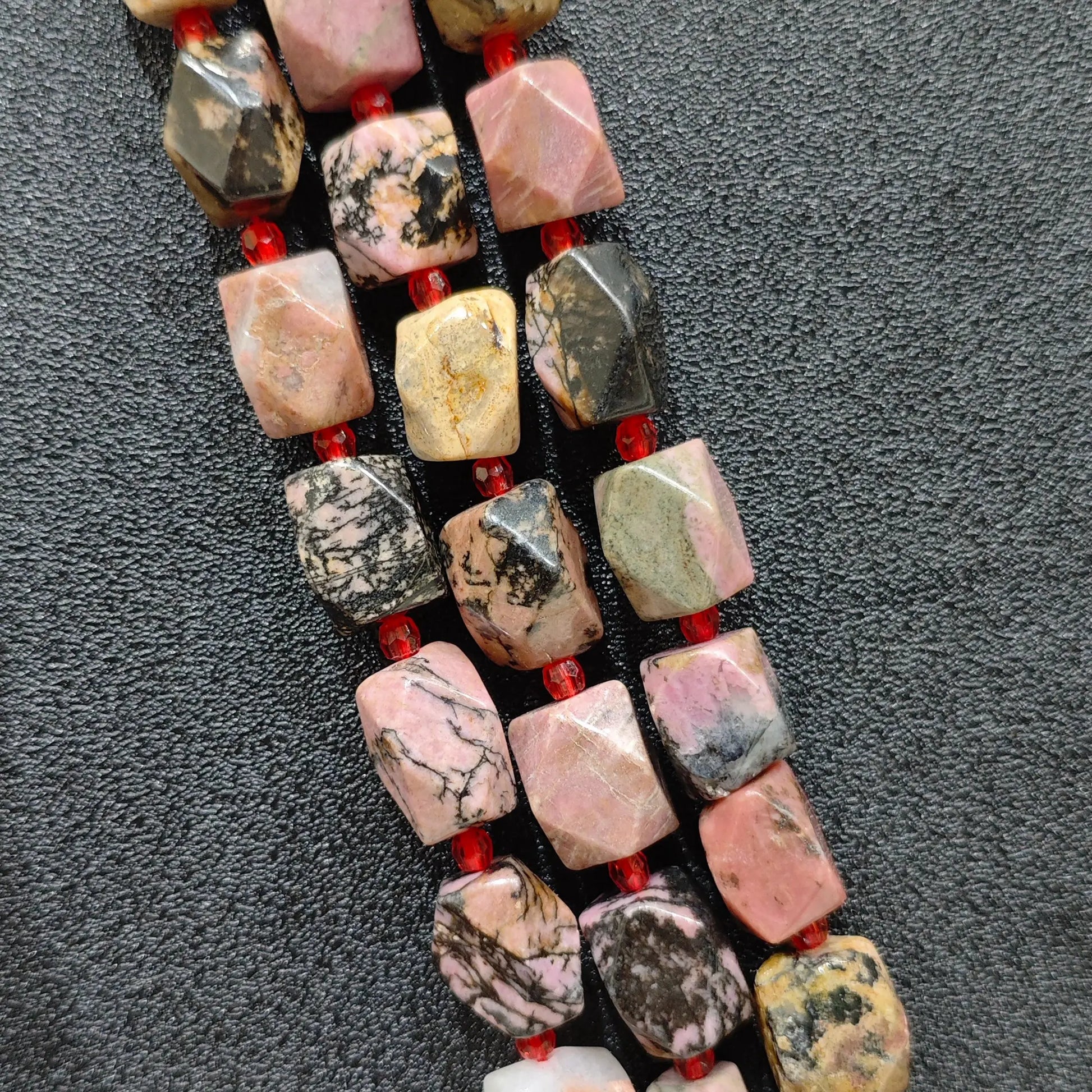 natural black veined rhodonite faceted barrel beads full strand view