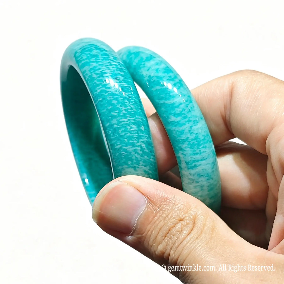 Side profile of two natural amazonite bangles highlighting smooth polish and vibrant mineral color