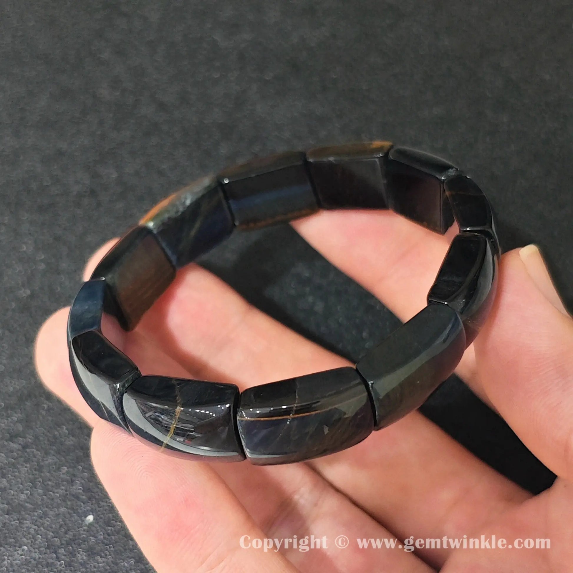 blue tigers eye plate stretch bracelet showcasing smooth glossy texture and subtle yellow mineral veins