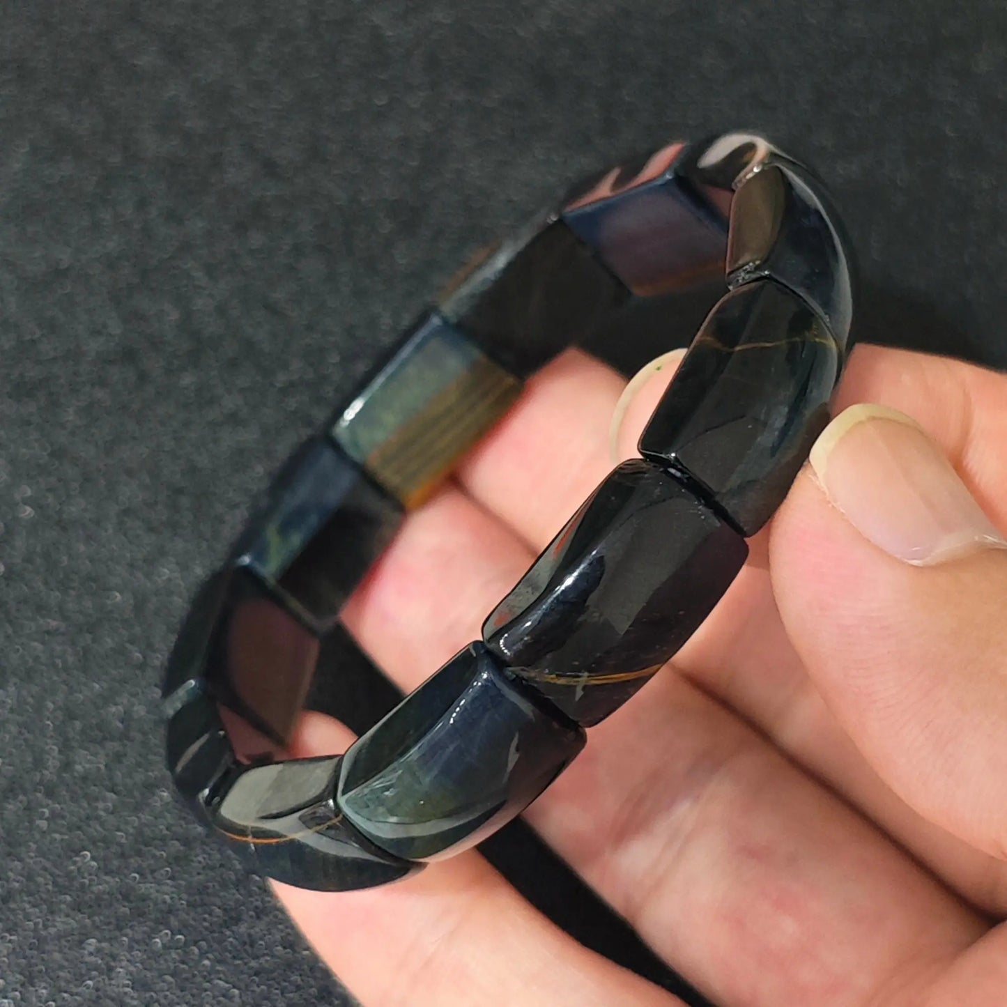 natural blue tigers eye plate cuff bracelet featuring 16mm curved beads held in hand with natural golden accents