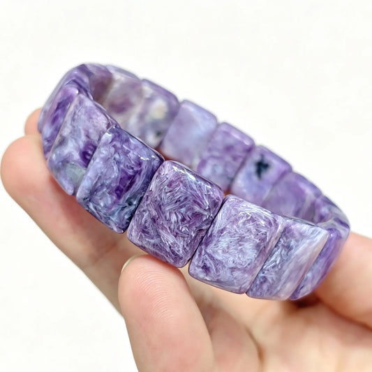 natural charoite bar bracelet displaying rich royal purple rectangular slabs with silky white feather patterns