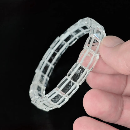 Natural clear quartz 10mm pyramid faceted square bead bracelet held in hand showing 3D geometric pyramid facets