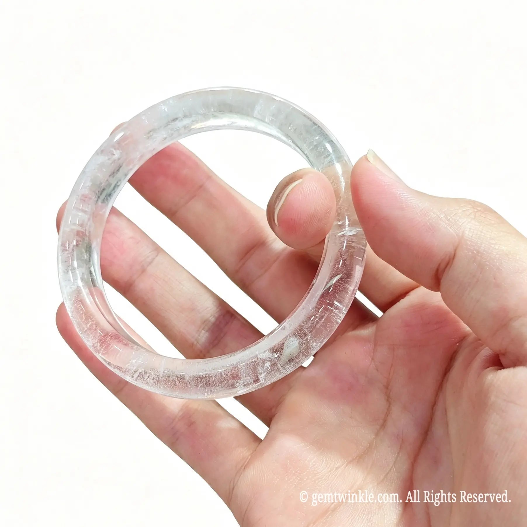 Side view of natural clear quartz gemstone bangles showing smooth polished edges