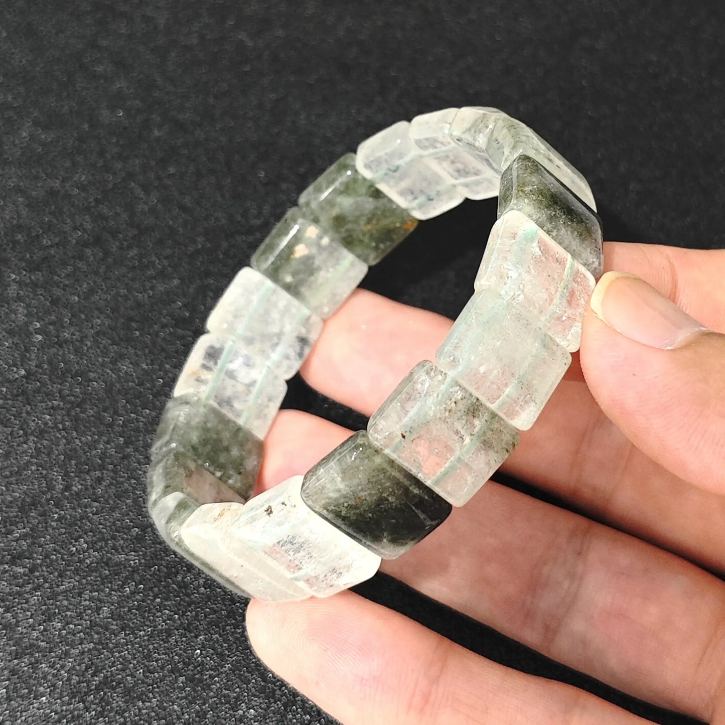 natural cloud phantom quartz plate bracelet held in hand showing chlorite inclusions and misty veils