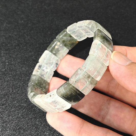 natural cloud phantom quartz plate bracelet held in hand showing chlorite inclusions and misty veils