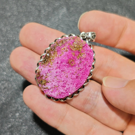 natural cobaltocalcite druzy pendant displaying vivid hot pink micro crystal clusters in a rope bezel frame