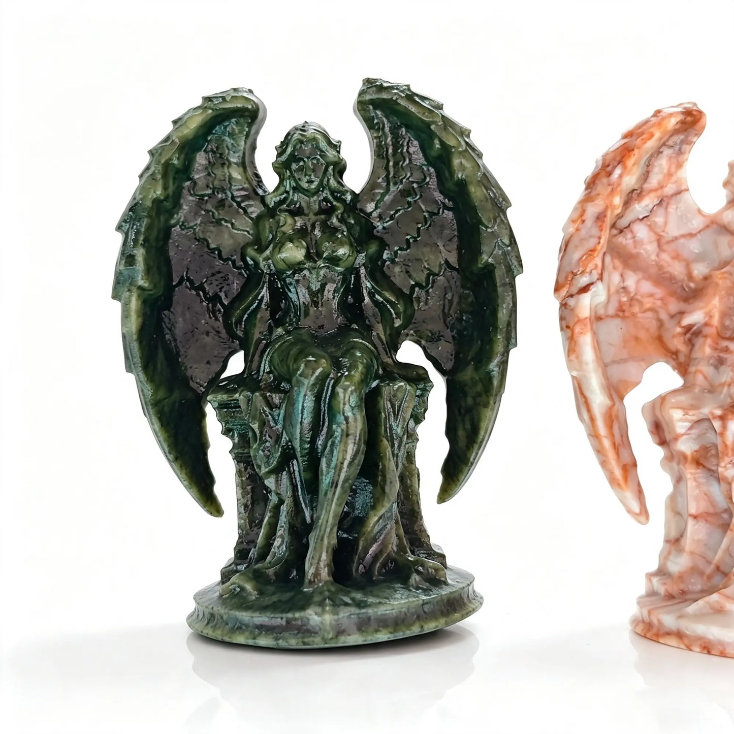 Single dark green natural stone angel statue 11cm seated on throne with raw carved texture on white background