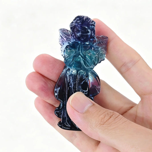 natural dark rainbow fluorite praying angel statue displaying rich violet purple and green natural color bands