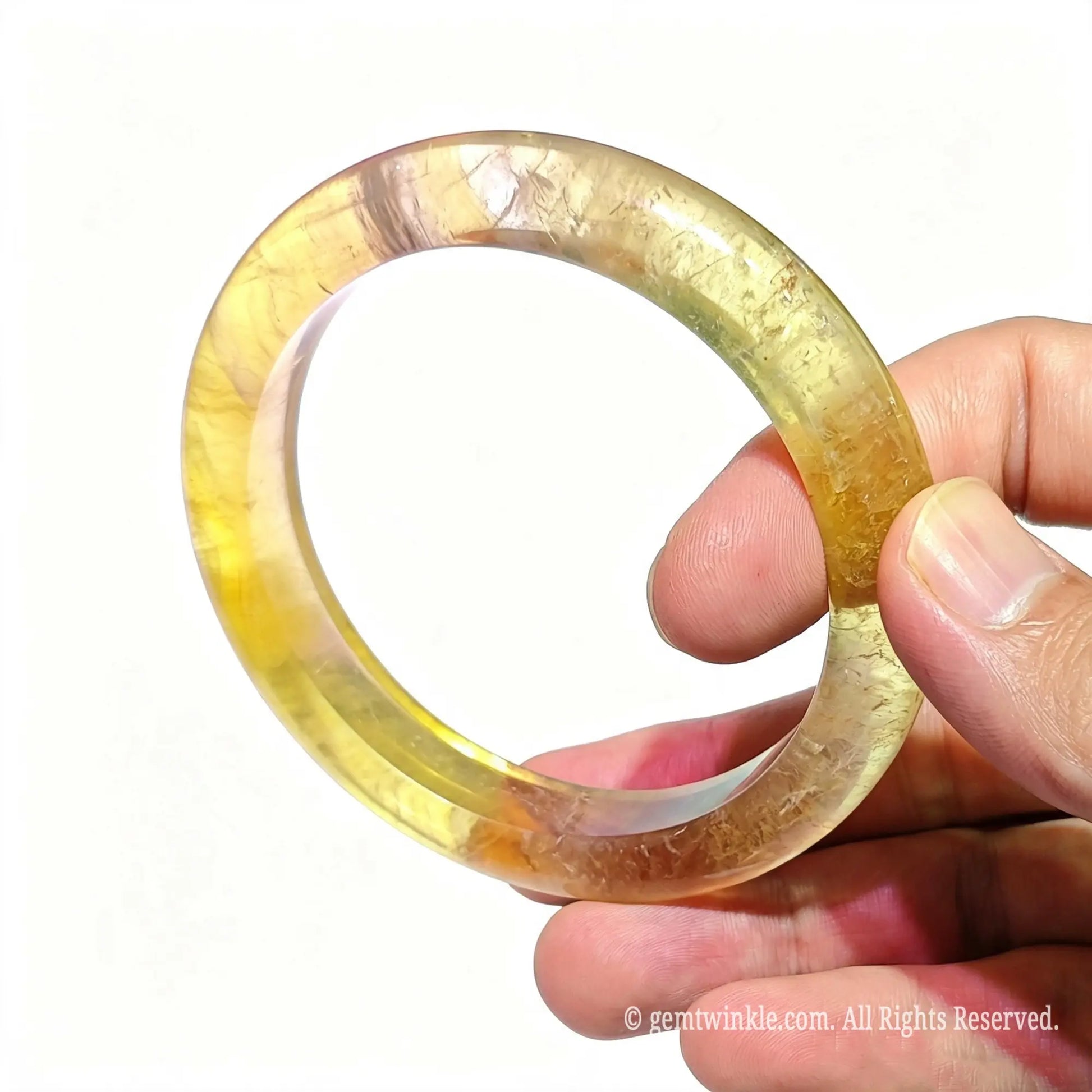 Natural fluorite stone bangle top view resting on palm showcasing handcrafted solid stone carving finish