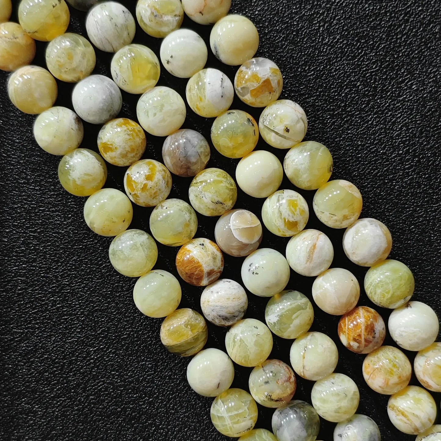 natural gemstone beads for jewelry making featuring genuine yellow opal matrix loose strands from 8mm to 10mm sizes on black background