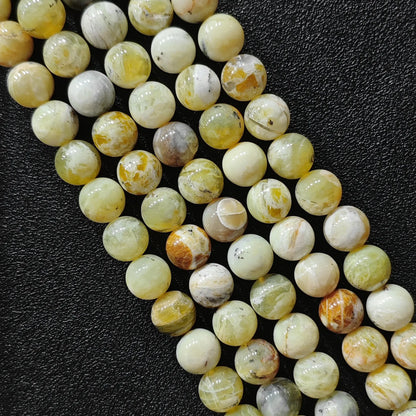 natural gemstone beads for jewelry making featuring genuine yellow opal matrix loose strands from 8mm to 10mm sizes on black background