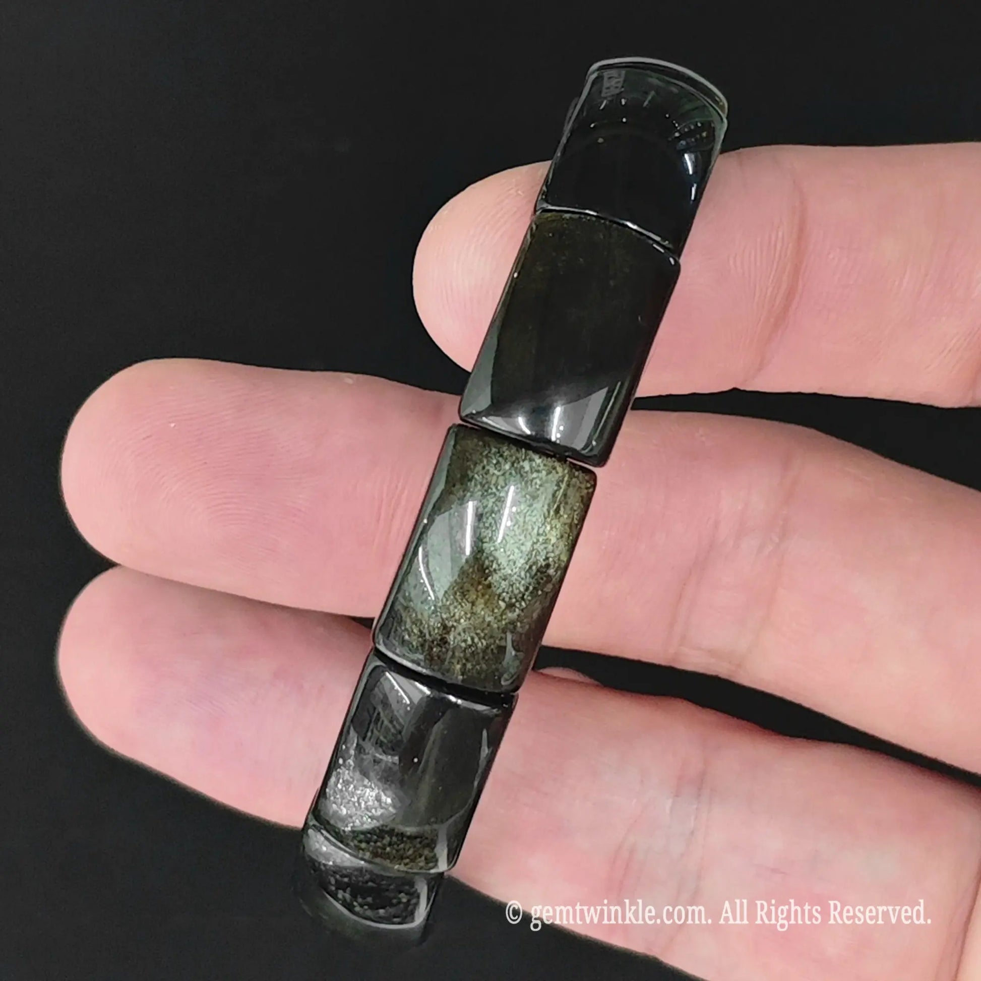 Natural gold sheen obsidian rectangle plate bead bracelet held vertically to display uniform bead layout and sheen