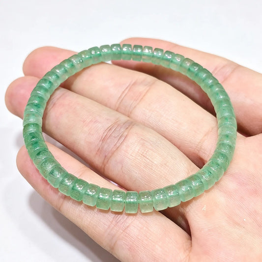 natural green aventurine disc cut gemstone bracelet held across hand showing delicate flat wheel beads