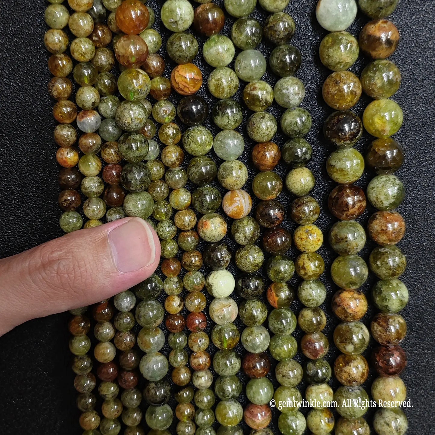 strands of natural green garnet gemstone beads in multiple small sizes