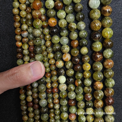 strands of natural green garnet gemstone beads in multiple small sizes