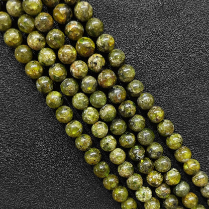 natural olive green peridot crystal beads close up view showing raw mineral textures