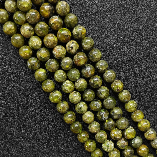 natural olive green peridot crystal beads close up view showing raw mineral textures